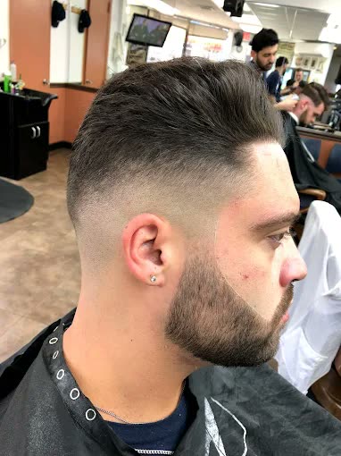 A burst fade finished with a shaped beard