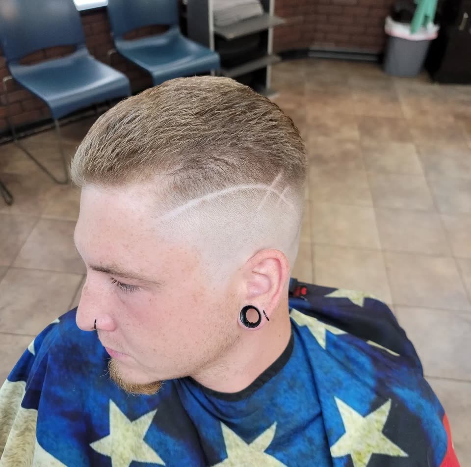 A high skin fade with a line design cut into the side