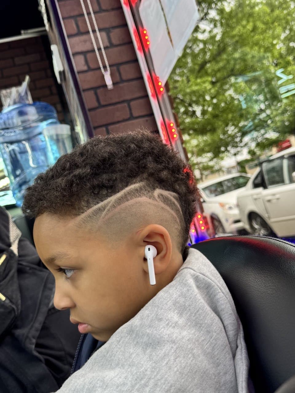 A boy's cut with a design shaved into the side