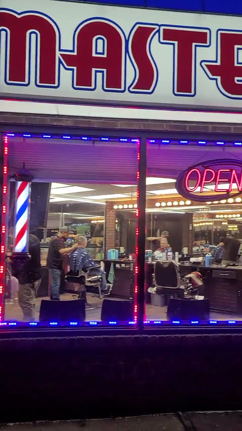 New York Master Barbers at night, the neon Master Barbers sign lit above the door
