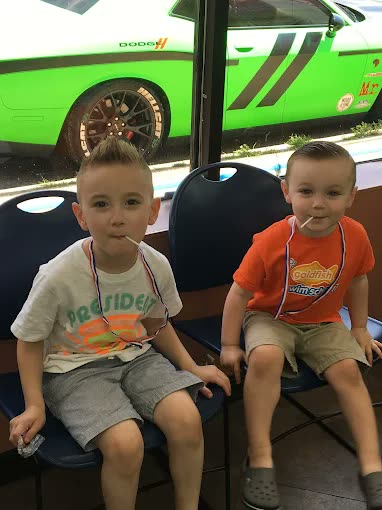Two children after their haircuts, second angle